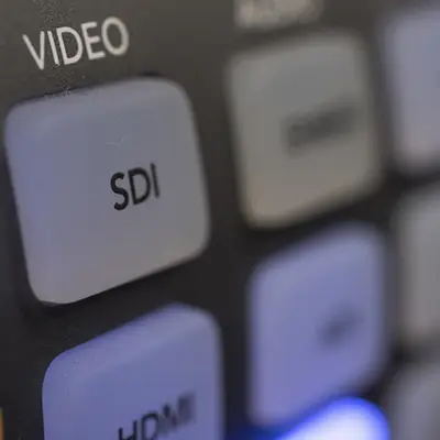 Close-up van een videomixer met duidelijk zichtbare SDI-knop, gebruikt voor professionele livestream laten maken.